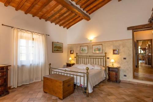 a bedroom with a bed and two tables and a mirror at Podere le Rote in Castelnuovo di Val di Cecina