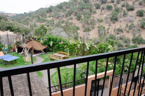 a balcony with a view of a garden at harmony surf lodge in Taghazout