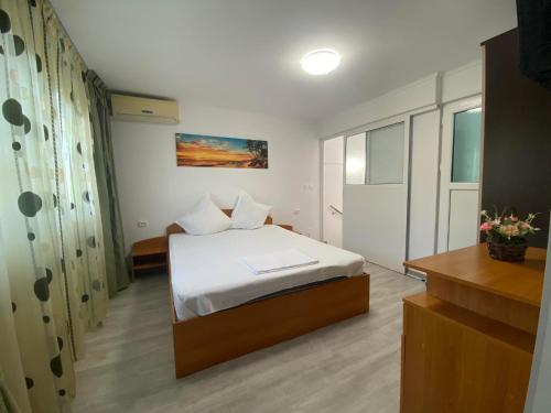 a bedroom with a bed in a room at Apartament A2 - EVIM in Mangalia