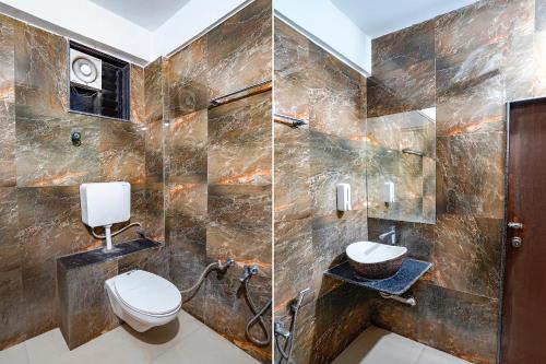 a bathroom with a toilet and a sink at FabHotel Relax - opp Hotel Leela in Gandhinagar