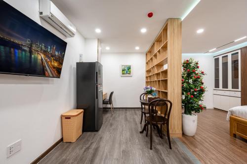 a room with a bed and a table and chairs at A Boi Apartment at District 3 in Ho Chi Minh City