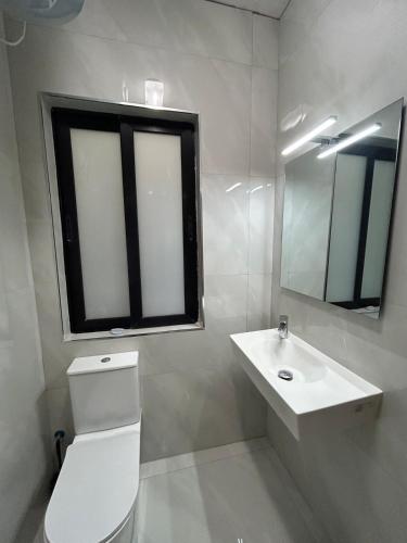 a bathroom with a toilet and a sink and a mirror at Brand new apartment in Paceville, St Julians in St Julian's