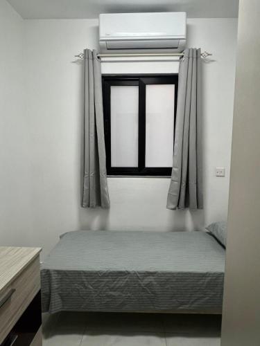 a bedroom with a bed and a window with curtains at Brand new apartment in Paceville, St Julians in St Julian's