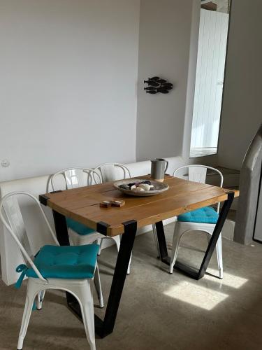 a dining room table with chairs and a plate on it at Serenity Hill in Kithnos