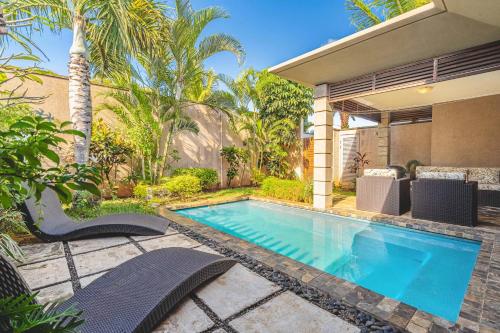 a swimming pool in the backyard of a house at Tropical Villa - 3 Bedrooms in the heart of Grand-Baie in Grand Baie