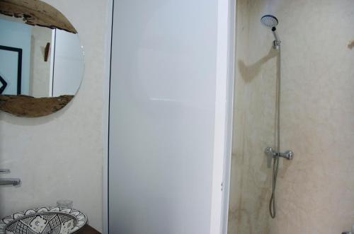 a shower in a bathroom with a mirror at harmony surf lodge in Taghazout