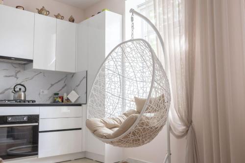 a hanging hammock chair in a kitchen next to a window at Central 2-Bedroom Cozy New Flat in Chişinău
