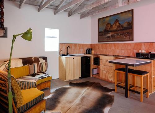 a kitchen with a couch and a table in a room at Entire Private Boutique Motel w Courtyard and Sauna in Marfa