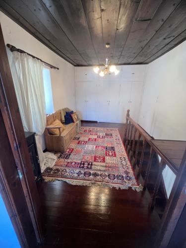 a room with a stairway with a rug on the floor at Castellum ac Mare in Mithymna