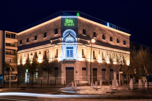 a building with a sign on the side of it at Ibis Styles Hyères Rooftop & Spa in Hyères