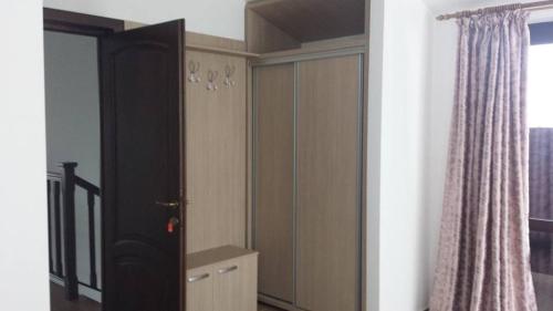 a bedroom with a cupboard and a window at Casa Aryana, adults only in Bran