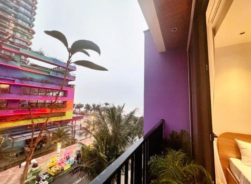 a balcony of a building with a view of the beach at Flamingo1 Ibiza Hai Tien in Nam Khê