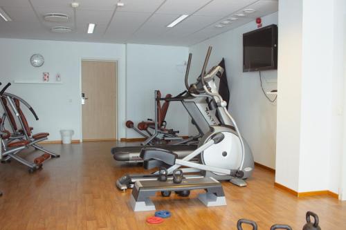 a gym with two exercise bikes and a treadmill at Hornavan Hotell in Arjeplog