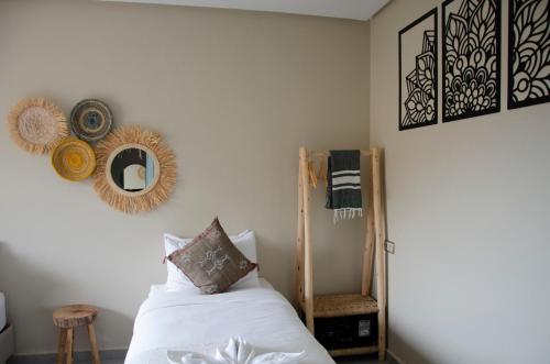 a bedroom with a bed and a mirror on the wall at harmony surf lodge in Taghazout