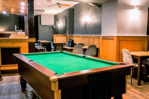 a pool table in a room with a bar at The Hillside Hotel & Restaurant in Hillside