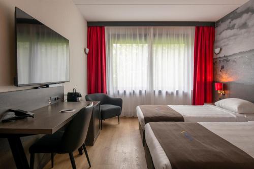 Postel nebo postele na pokoji v ubytování Bastion Hotel Almere