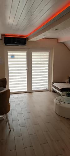 a large room with two windows and a bed at RB Apartment 1 (SPA) & 2 in Palić