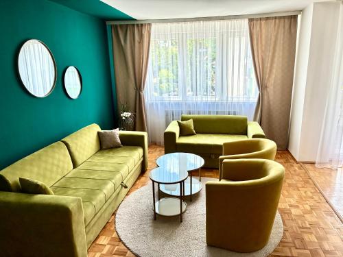 a living room with two couches and a table at Apartman Minja in Višegrad