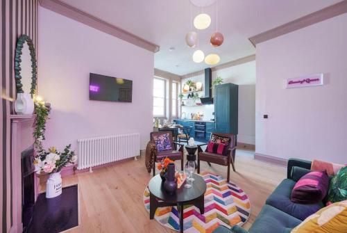 a living room with a couch and a table at The Half Angel apartment at The Bank of England in Bristol