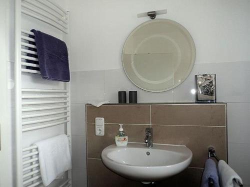 a bathroom with a sink and a mirror at "Villa Lorenzo" in Bad Zwischenahn