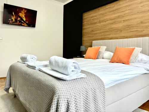 a bedroom with two beds with towels on a table at Apartman Minja in Višegrad
