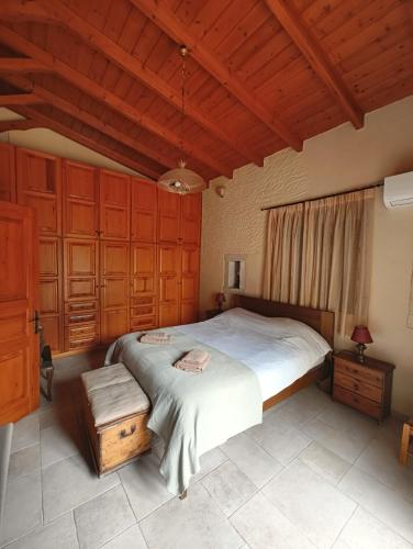 a bedroom with a large bed and wooden cabinets at Refoulo Tower in Poliána