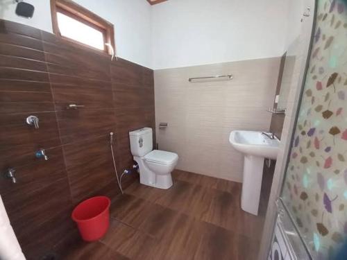 a small bathroom with a toilet and a sink at Forest Glen Nest Ella in Bandarawela