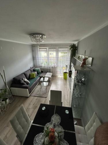 a living room with a table and a couch at BM Apartament in Augustów