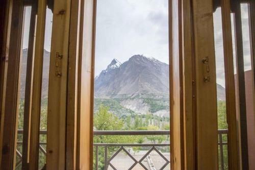 a window with a view of a mountain at Karakorum View Hotel Karimabad Hunza in Hunza