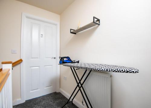 a room with a counter and a white wall at Luxury 5BDR with City Access, Free Parking and Wi-Fi in Ince-in-Makerfield