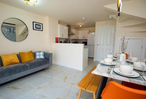 a living room with a couch and a table at Luxury 5BDR with City Access, Free Parking and Wi-Fi in Ince-in-Makerfield