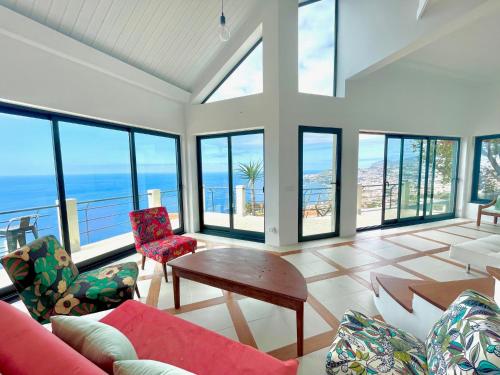 a living room with a lot of windows at TheView in Funchal