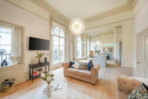 a living room with a couch and a tv at The Sovereign suite apartment at The Bank of England in Bristol