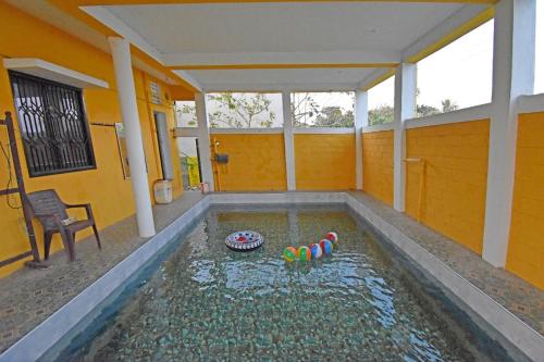 a house with a swimming pool in the middle of it at paradise beach resort pondicherry in Pūrnānkuppam