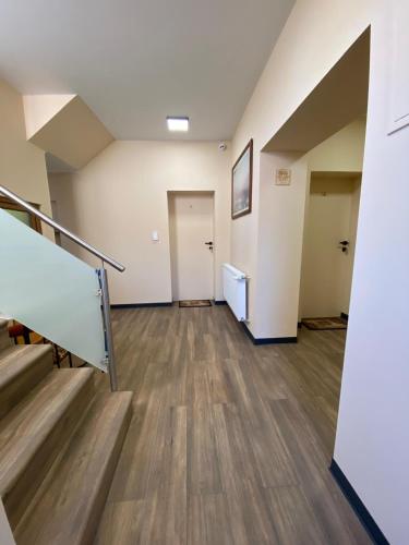 an empty room with stairs and a hallway at Drivers in Woźniki
