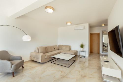 a living room with a couch and a table at Bella Vista Luxure Apartments in Baošići