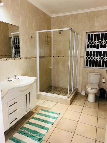 a bathroom with a shower and a sink and a toilet at Crayfish in Vredenburg