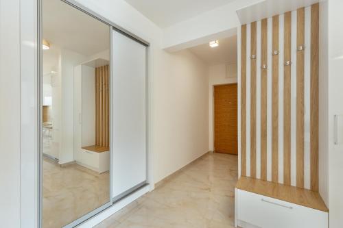 a hallway with a large glass door and a hallway with at Bella Vista Luxure Apartments in Baošići