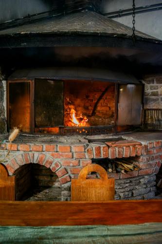 a brick oven with a fire inside of it at Keresztkúti Erdei Pihenőhely in Kőszeg