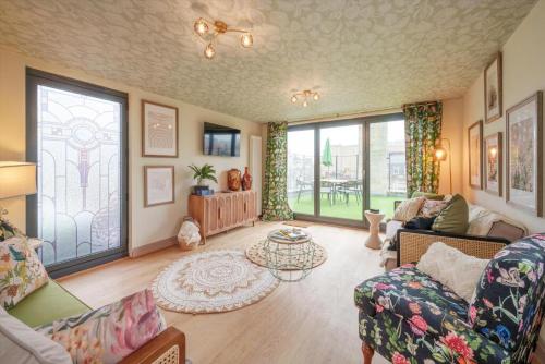a living room with a couch and a table at Tellers secret loft apartment The Bank of England in Bristol