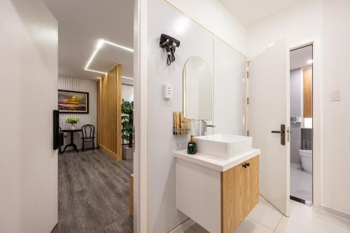 a bathroom with a sink and a mirror at A Boi Apartment at District 3 in Ho Chi Minh City