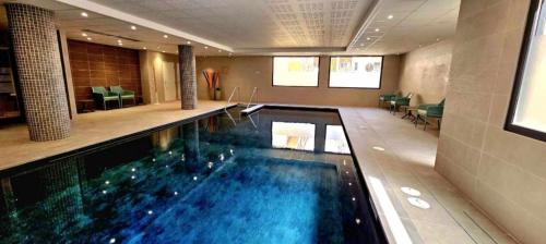 a large swimming pool in a hotel room at DOMITYS - La Via Domitia in Gap