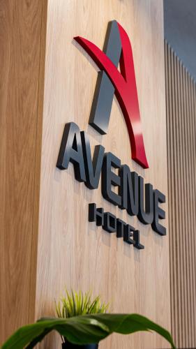 a sign for aaneury hilton on the side of a building at Avenue Hotel in Burgas