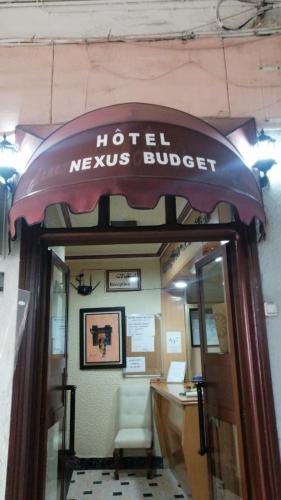 a hotel nexus buffet sign over the door of a building at Hôtel Nexus Budget in Al Hoceïma