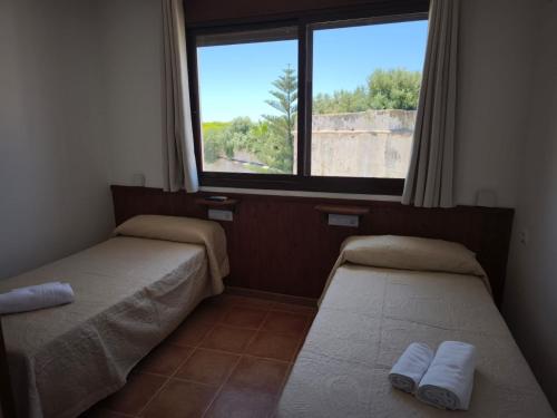 Posteľ alebo postele v izbe v ubytovaní Hostal Jadraza