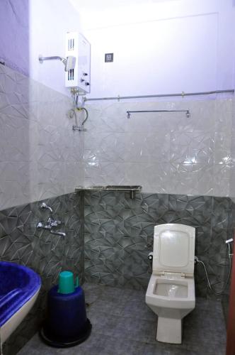 a bathroom with a toilet and a sink and a tub at Aayana Valley in Chikmagalur