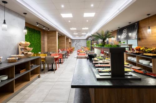 a restaurant with a buffet line of food at Avenue Hotel in Burgas City