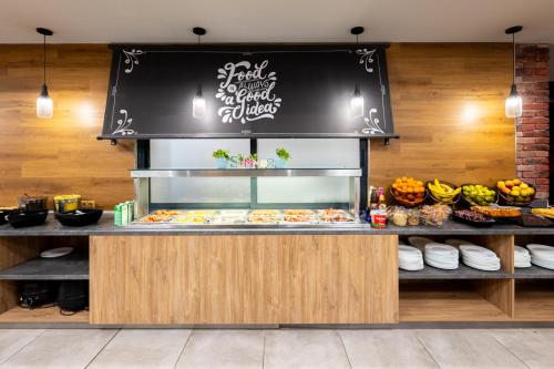 a bakery with a counter with food on it at Avenue Hotel in Burgas City