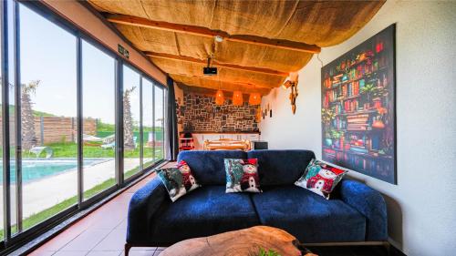 a blue couch in a living room with windows at Grand Paradise Resort Sapanca in Sapanca