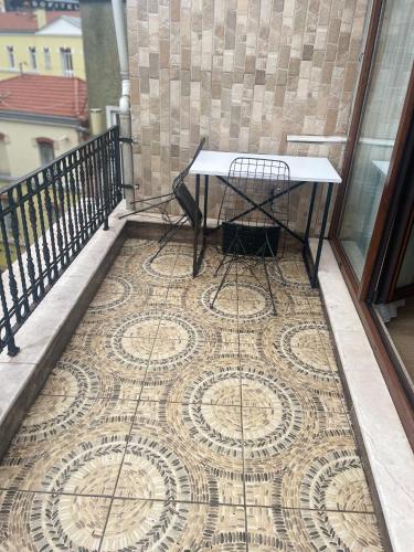 a table on a balcony with a mosaic floor at TAKSiM PARK HOTEL in Istanbul